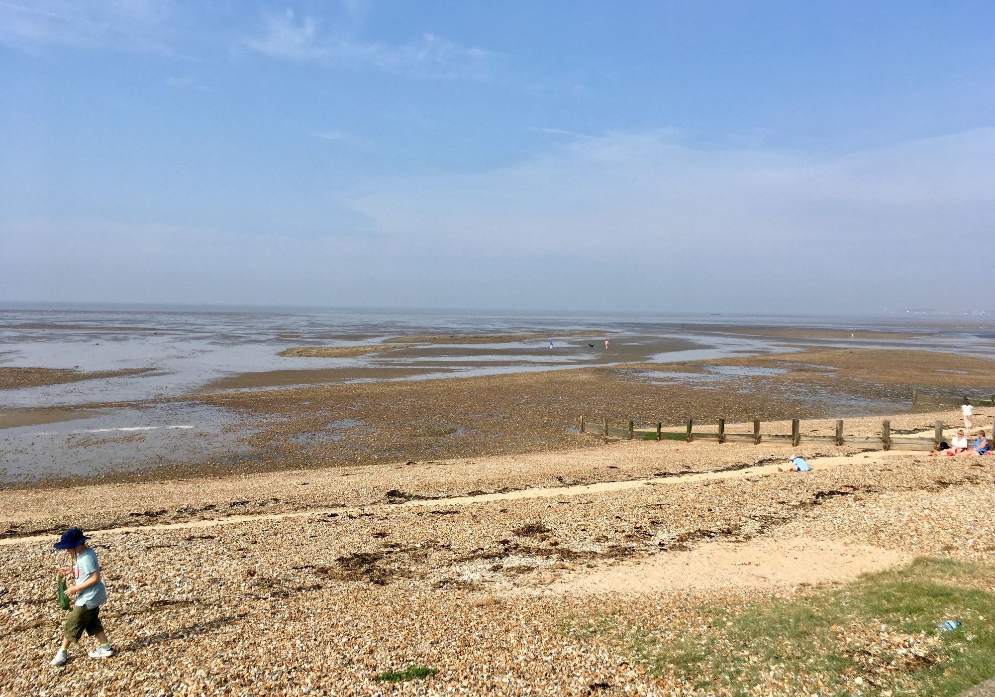 Low tide on Seasalter beach, with sand and shingle stretching out under a wide sky